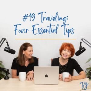 Two women sharing travel tips over coffee and a laptop.