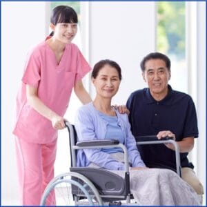 Caregiver assisting elderly woman in wheelchair with family support.