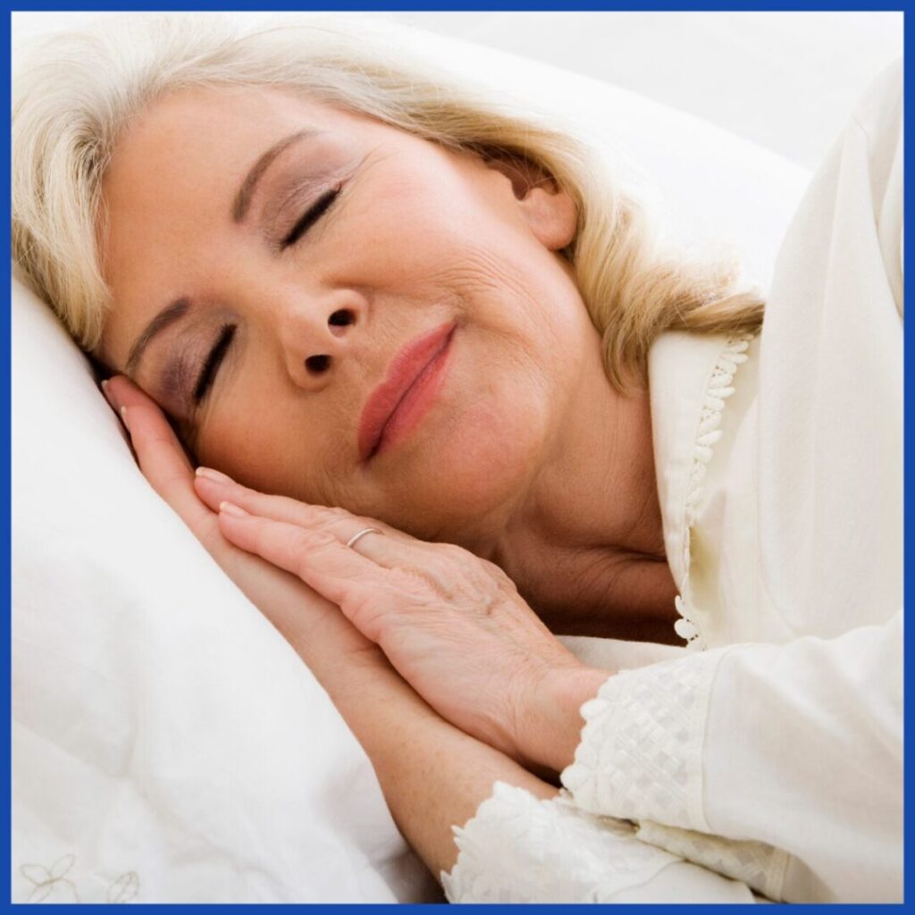 Peaceful elderly woman sleeping comfortably in bed.